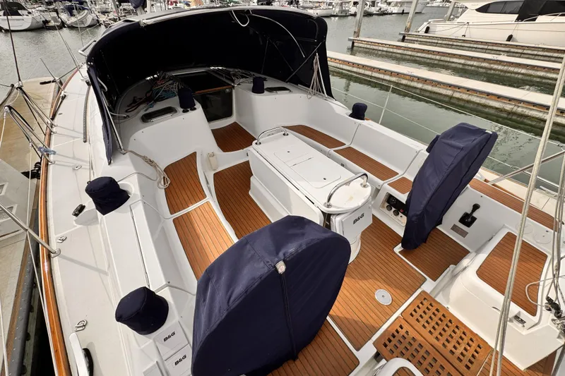 2007 Jeanneau Sun Odyssey 49 Performance sailboat cockpit with teak flooring and covered seating.