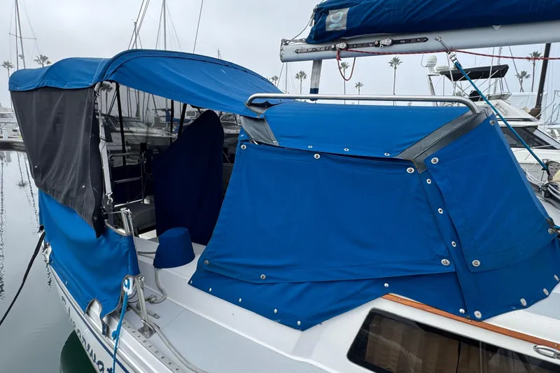 1991 Catalina 36MKI sailboat with blue canvas cover docked at marina.