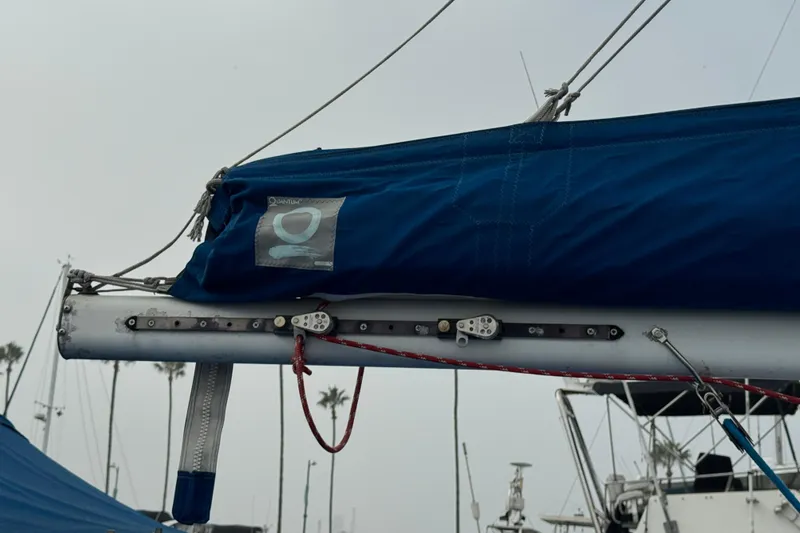 Sailboat boom with blue cover on 1991 Catalina 36MKI, docked in marina.
