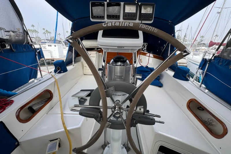 Cockpit of 1991 Catalina 36MKI sailboat with steering wheel and navigation instruments.