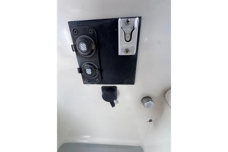 Control panel on 1991 Catalina 36MKI boat, featuring switches and outlets.