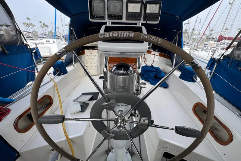 Cockpit of a 1991 Catalina 36MKI sailboat with steering wheel and navigation instruments.