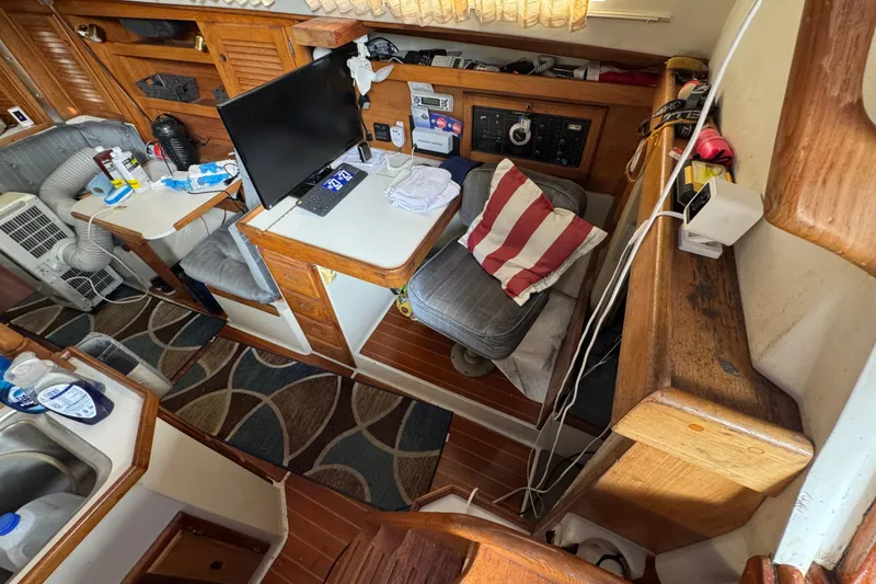 Interior of a 1991 Catalina 36MKI sailboat with cozy seating and navigation equipment.
