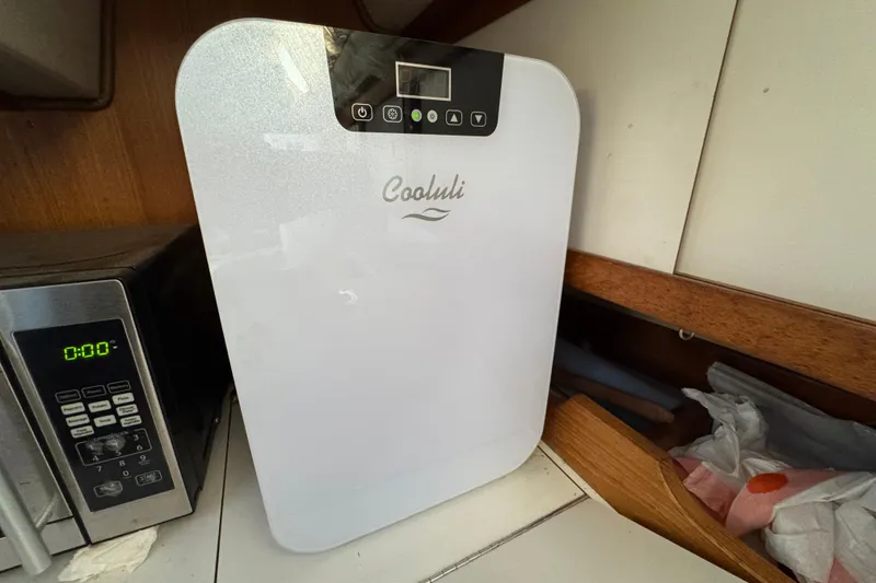 Cooluli mini fridge on a Catalina 36MKI yacht, 1991 model, beside a microwave.