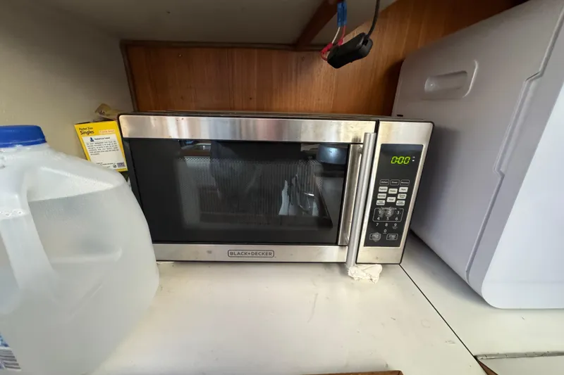 Black & Decker microwave on Catalina 36MKI yacht, 1991 model, with water jug nearby.