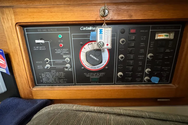 Control panel of a 1991 Catalina 36MKI sailboat with various switches and indicators.