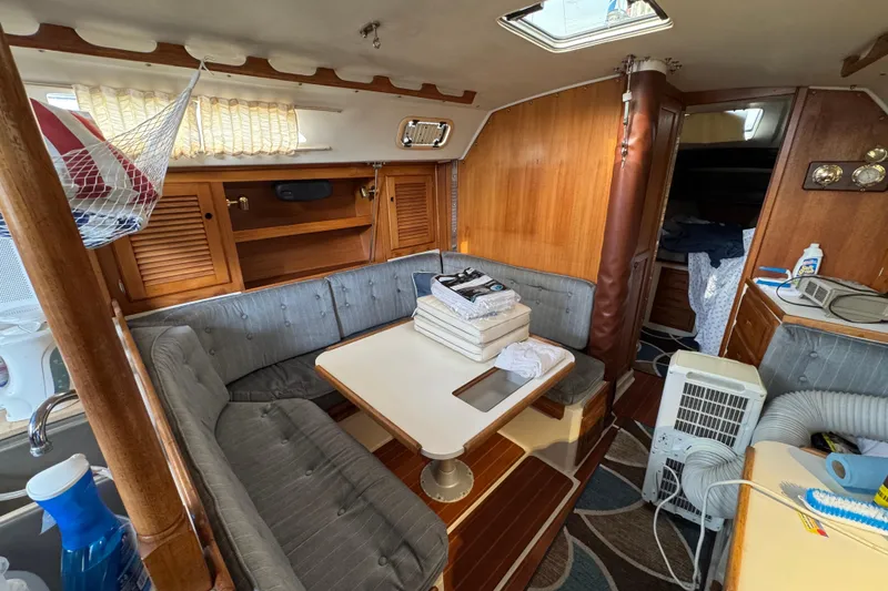 Interior of a 1991 Catalina 36MKI sailboat with cozy seating and wooden accents.