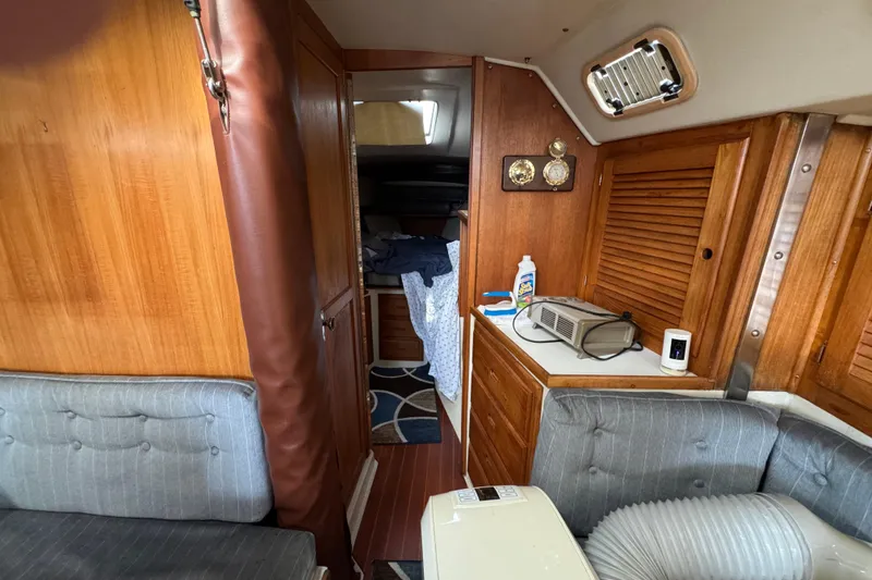 Interior of a 1991 Catalina 36MKI sailboat with wooden cabinetry and seating.