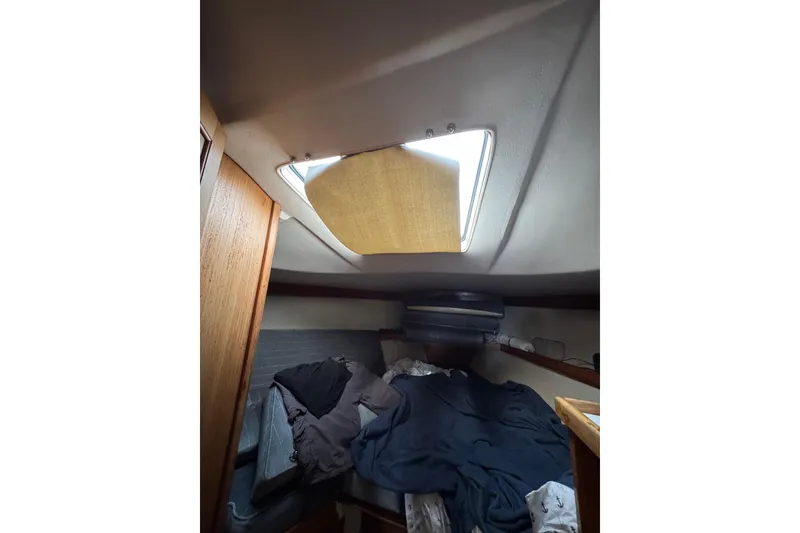 Interior cabin of a 1991 Catalina 36MKI sailboat with bedding and a skylight.