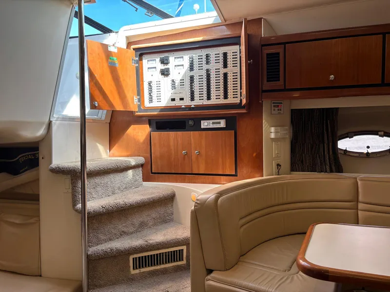 Interior of a 1998 Trojan 400 yacht with control panel and seating area.