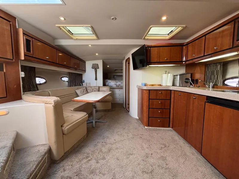 Luxurious interior of a 1998 Trojan 400 yacht with elegant wood cabinetry and plush seating.
