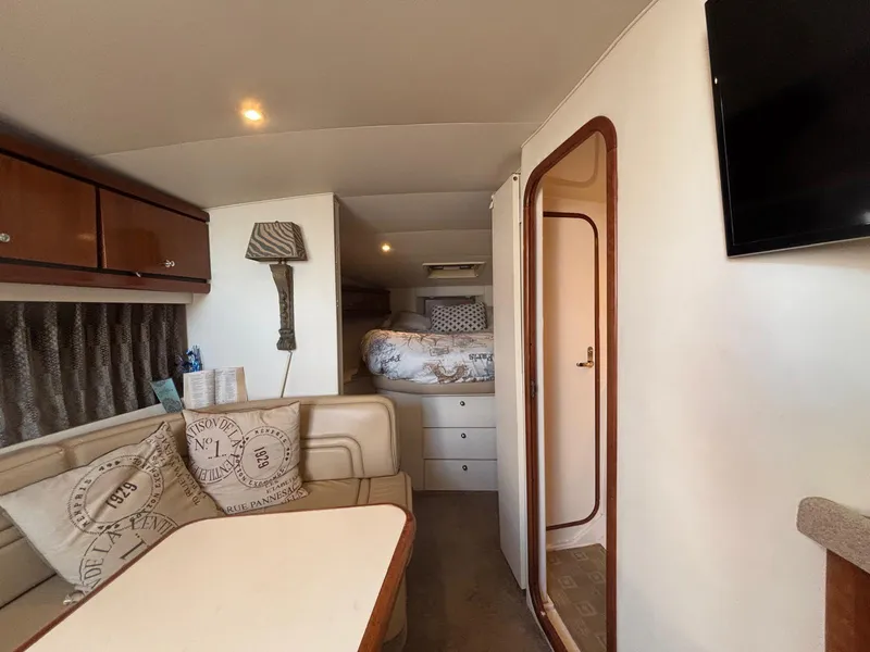 1998 Trojan 400 yacht interior with cozy seating, bed, and modern amenities.