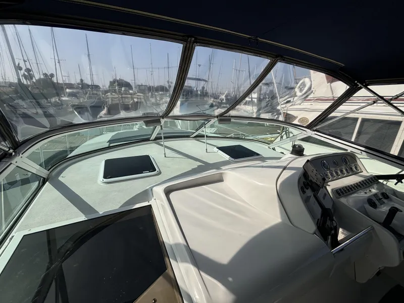 Cockpit view of a 1998 Trojan 400 boat docked in a marina.