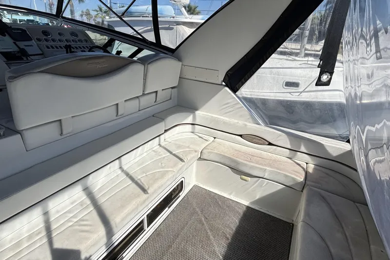 Interior of a 1998 Trojan 400 yacht with white seating and control panel.