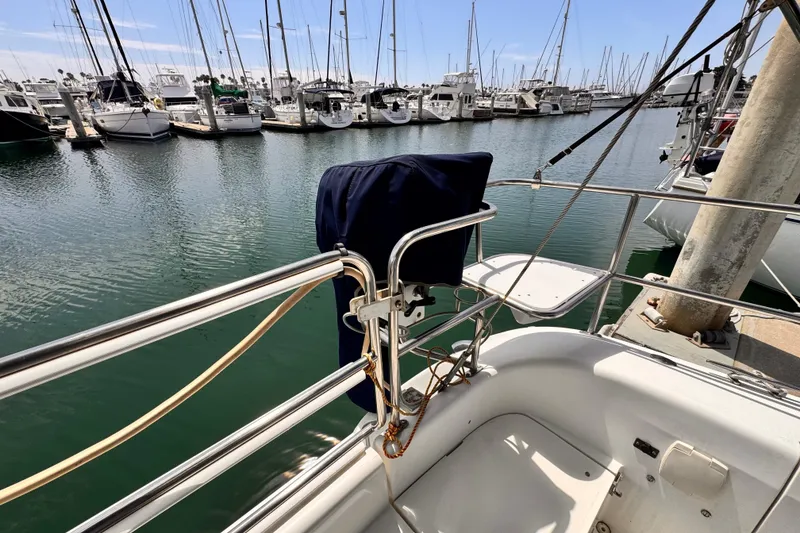 2006 Catalina 34 MkII sailboat docked in a marina, surrounded by other boats.