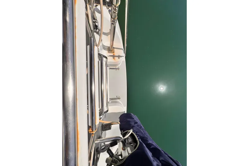 Catalina 34 MkII sailboat deck view, 2006 model, reflecting on calm water.