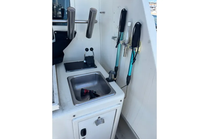Fishing gear and sink on 1985 Hatteras 45 Convertible boat deck.