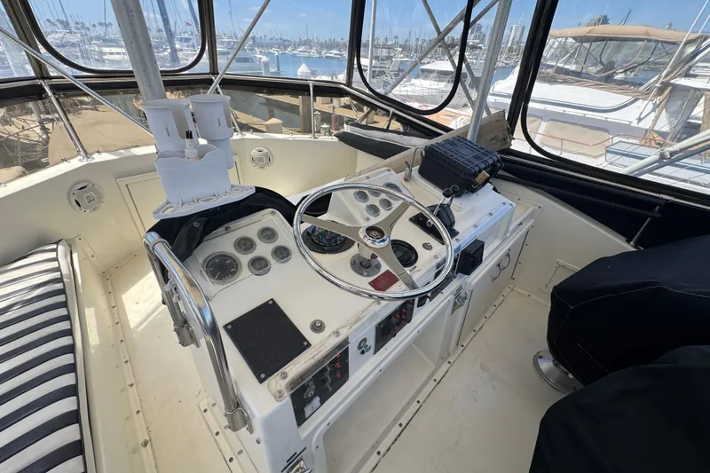 Cockpit of 1985 Hatteras 45 Convertible yacht with steering wheel and control panel.