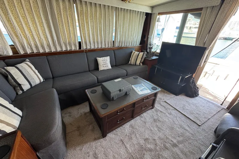 Interior of 1985 Hatteras 45 Convertible yacht with cozy seating and TV.