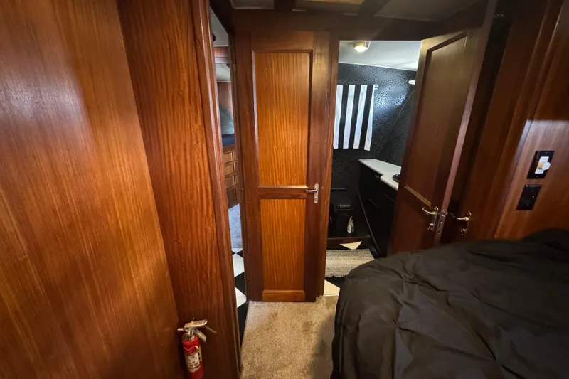 Interior of 1985 Hatteras 45 Convertible yacht with wood paneling and modern bathroom.