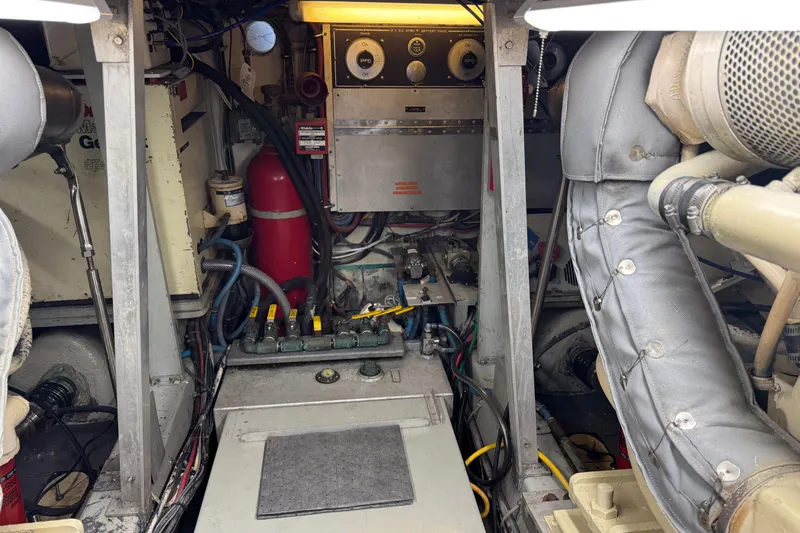 Engine room of a 1985 Hatteras 45 Convertible yacht, featuring mechanical components and wiring.