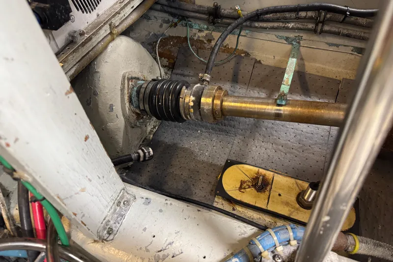 Engine room of a 1985 Hatteras 45 Convertible boat, showing mechanical components and wiring.