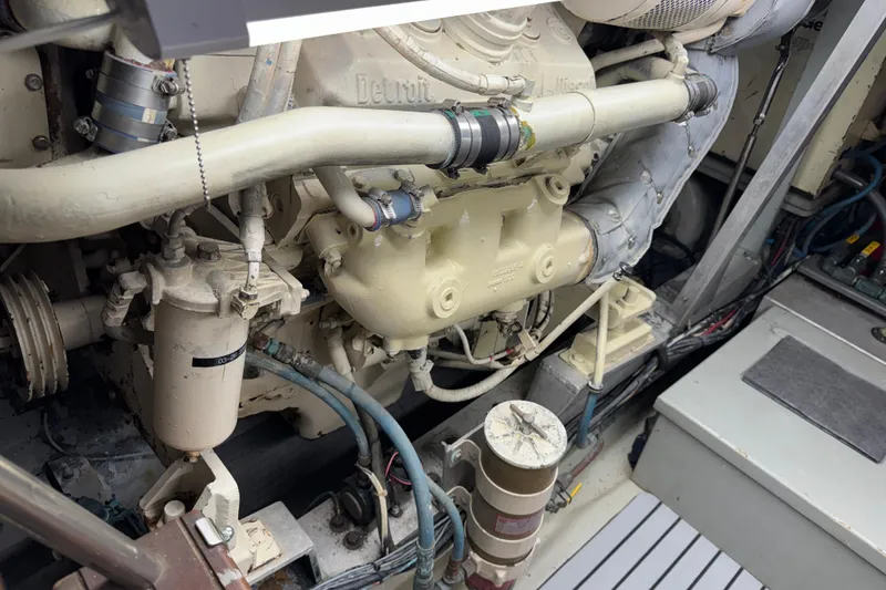 Engine room of a 1985 Hatteras 45 Convertible yacht, showcasing mechanical components.