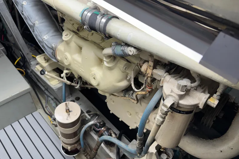 Engine compartment of a 1985 Hatteras 45 Convertible boat, showcasing mechanical components.