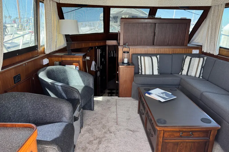 Interior of 1985 Hatteras 45 Convertible yacht with cozy seating and nautical decor.