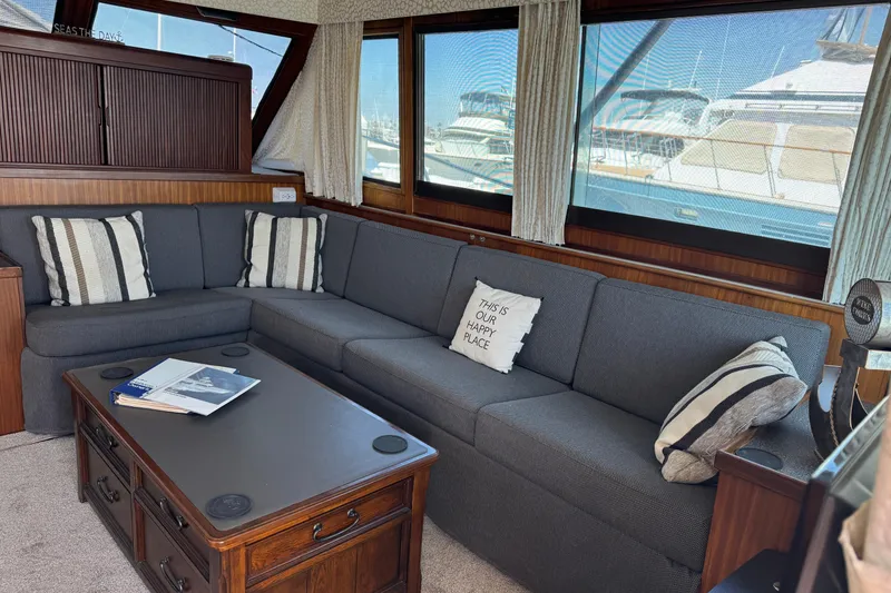 Interior of 1985 Hatteras 45 Convertible yacht with cozy seating and nautical decor.