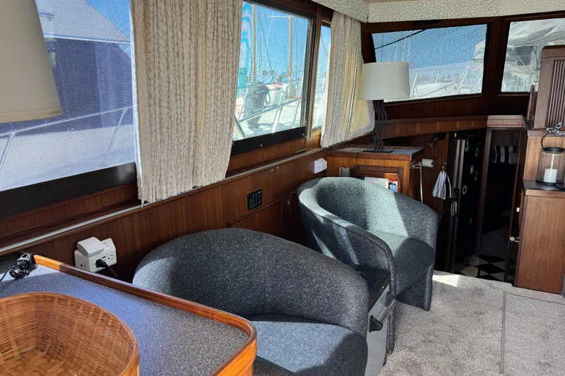 Interior of 1985 Hatteras 45 Convertible yacht with cozy seating and wooden accents.
