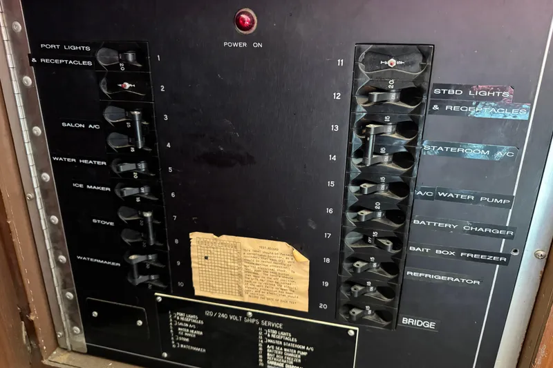 Electrical panel of a 1985 Hatteras 45 Convertible boat with labeled switches.