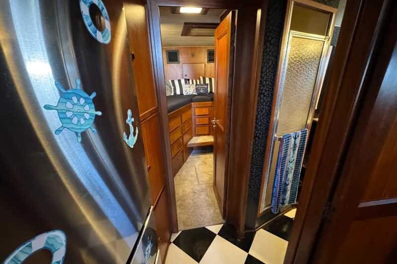 Interior of 1985 Hatteras 45 Convertible yacht with nautical decor and wooden cabinetry.