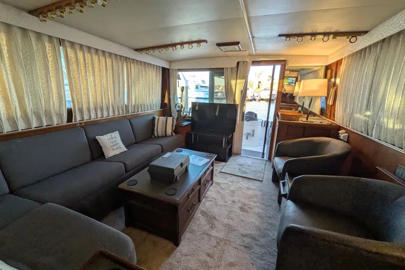 Interior of 1985 Hatteras 45 Convertible yacht with cozy seating and elegant decor.