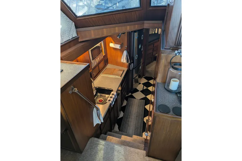 Interior of 1985 Hatteras 45 Convertible yacht, featuring a compact kitchen area.