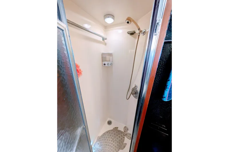 Shower area inside 1985 Hatteras 45 Convertible yacht, featuring a compact design and modern fixtures.