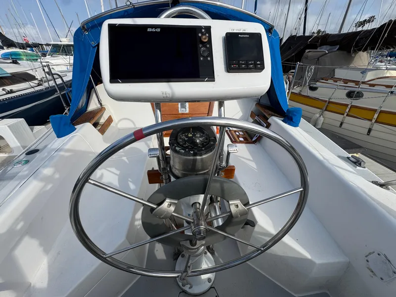 Steering wheel and navigation system on a 1990 Catalina 30 MkII sailboat.