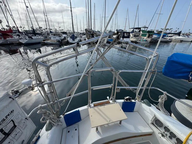 1990 Catalina 30 MkII sailboat in marina, surrounded by other boats.