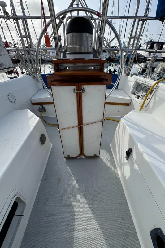 1990 Catalina 30 MkII sailboat cockpit with steering wheel and navigation equipment.