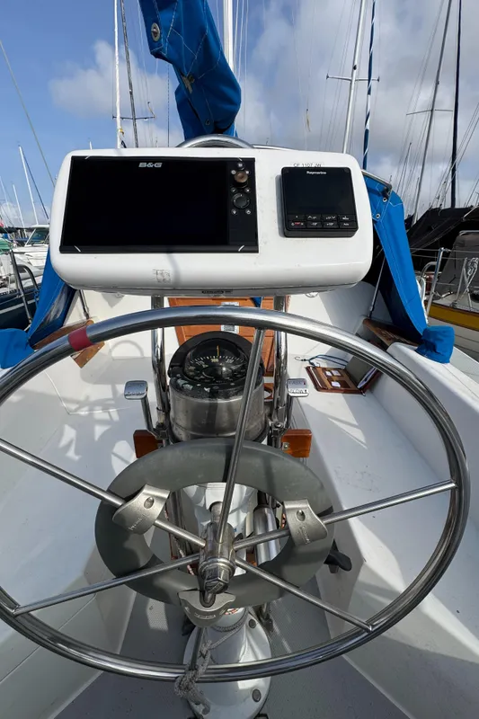 Steering wheel and navigation equipment on a 1990 Catalina 30 MkII sailboat.