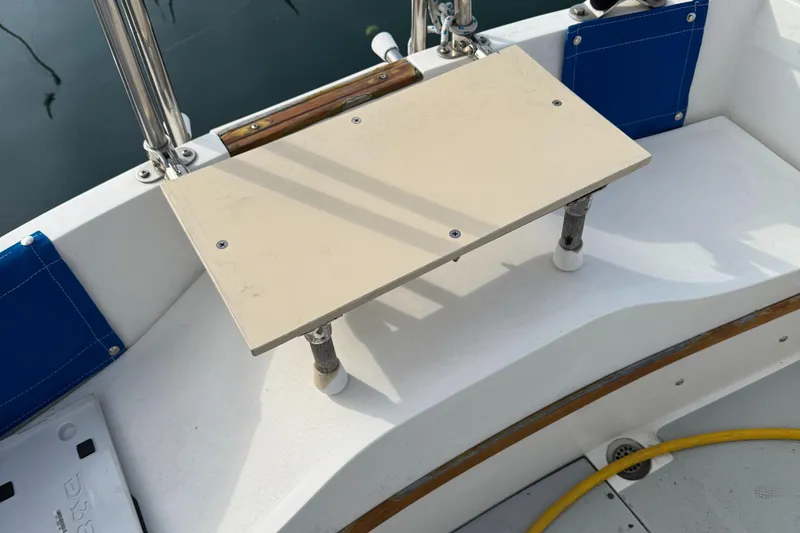 Cockpit seating area of a 1990 Catalina 30 MkII sailboat with a foldable table.