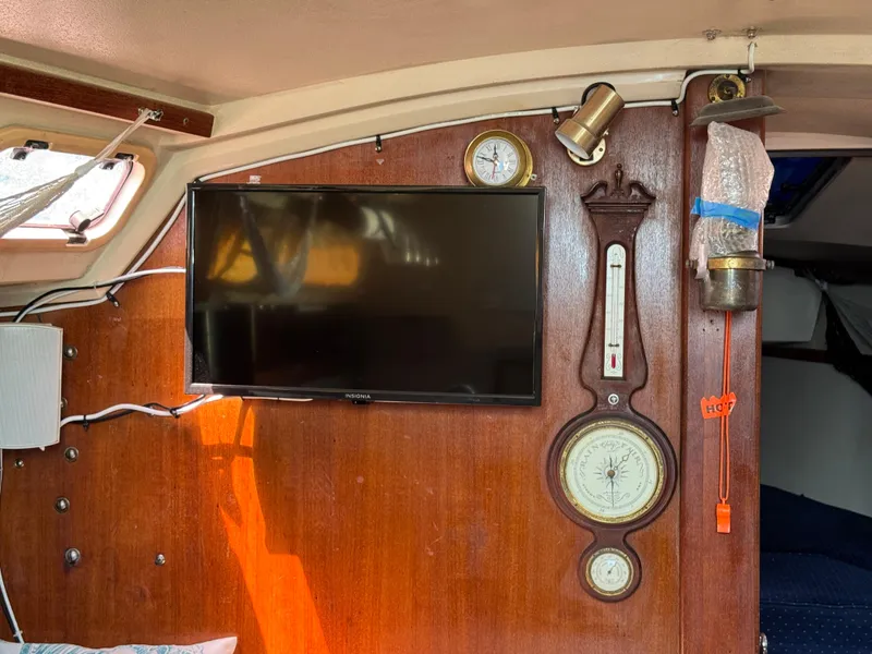 Interior of a 1990 Catalina 30 MkII sailboat with mounted TV and nautical instruments.