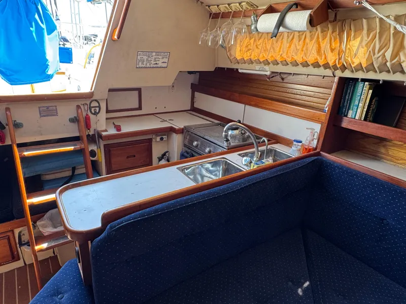Interior of 1990 Catalina 30 MkII sailboat with kitchen and seating area.