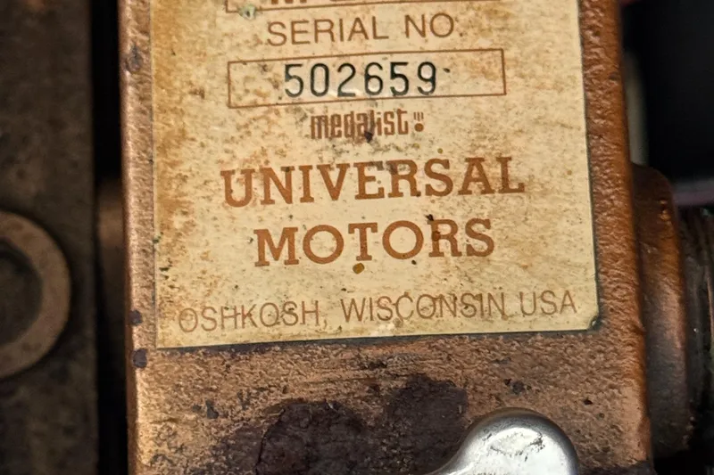 Close-up of a Universal Motors label with serial number 502659, Oshkosh, Wisconsin, USA.