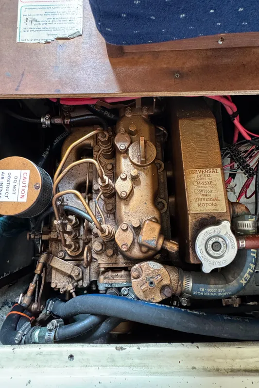 Engine of a 1990 Catalina 30 MkII sailboat, featuring detailed mechanical components.