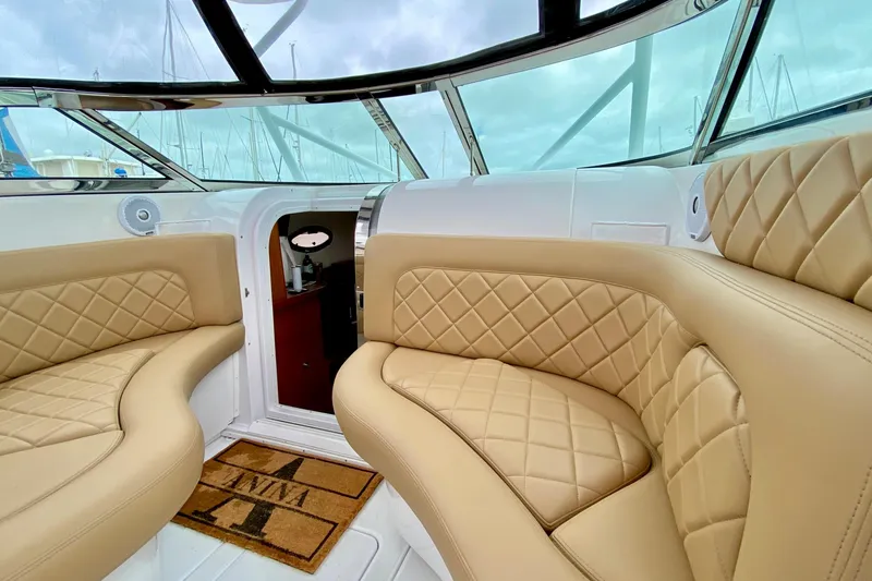 Luxurious interior of a 2006 Donzi 38 ZSF boat with tan quilted seating.