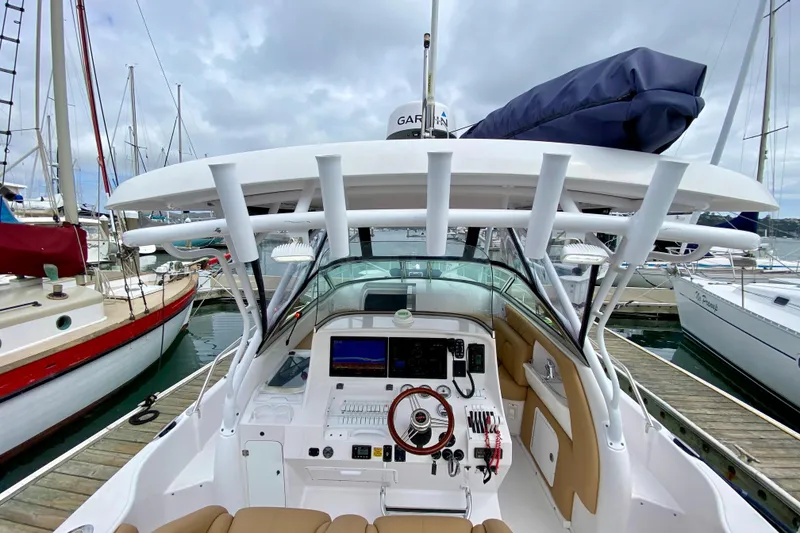 2006 Donzi 38 ZSF boat cockpit with modern controls, docked at marina.