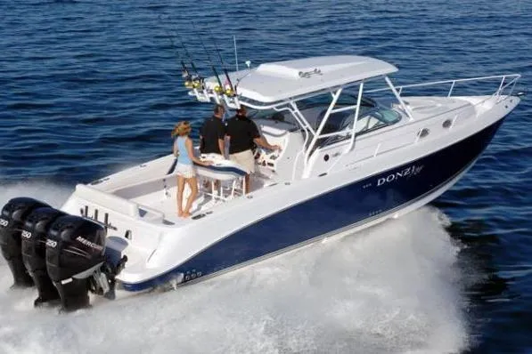 2006 Donzi 38 ZSF boat cruising on open water with passengers onboard.