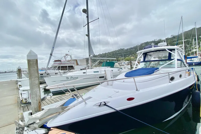 2006 Donzi 38 ZSF boat docked at a marina under cloudy skies.
