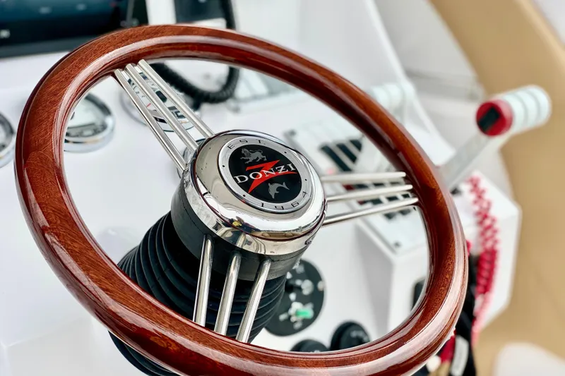 Steering wheel of a 2006 Donzi 38 ZSF boat, featuring a polished wood finish.